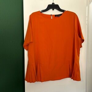 Orange blouse with accordion sides and keyhole back